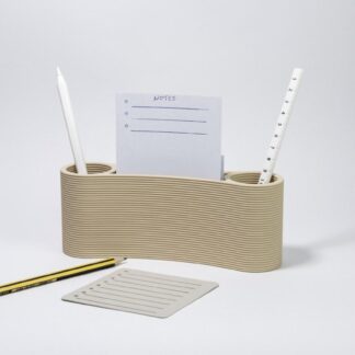 3D printed beige binocular-shaped desk organizer with pens and notepad