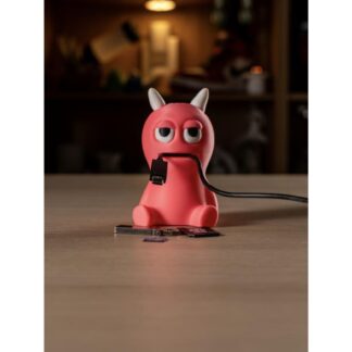 3D printed pink cable monster desk organizer holding a charging cable