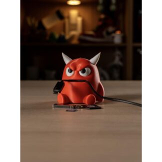 3D printed red cable monster desk organizer holding a charging cable