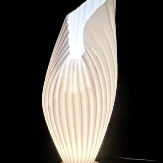 3D printed white leaf-shaped table lamp glowing warm light