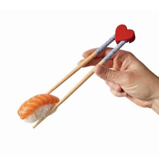 3D printed heart-shaped chopstick rest holding chopsticks with sushi