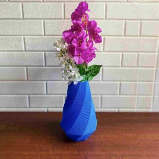 3D printed blue faceted flower vase with fresh flowers